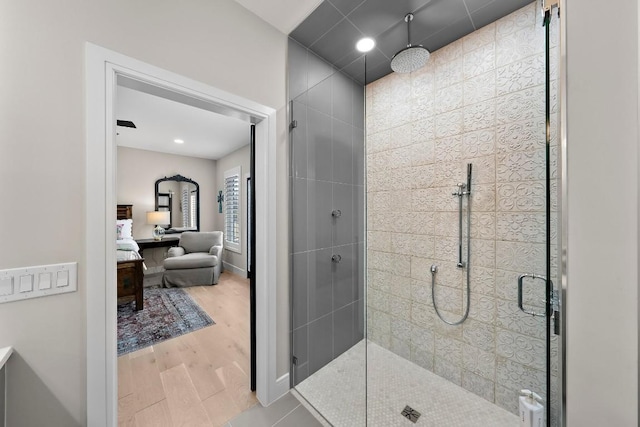 bathroom featuring an enclosed shower and hardwood / wood-style flooring