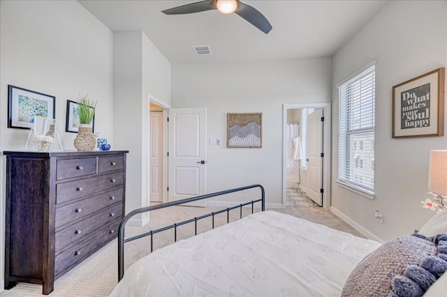 carpeted bedroom with ceiling fan and connected bathroom