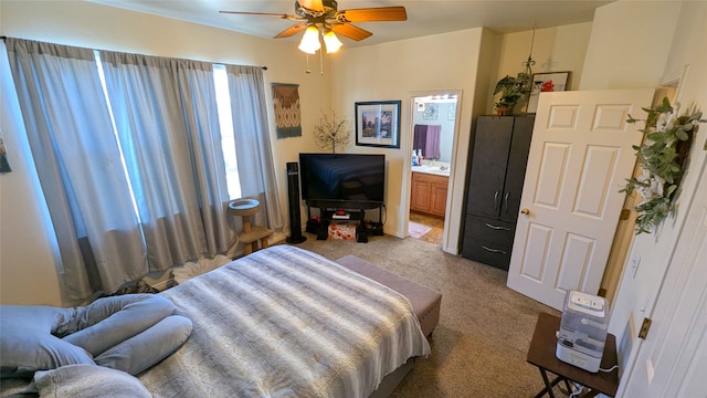 carpeted bedroom with connected bathroom and ceiling fan