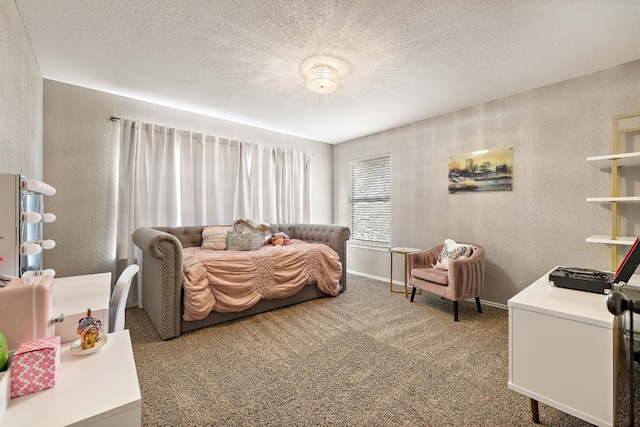 bedroom featuring a textured ceiling and carpet flooring