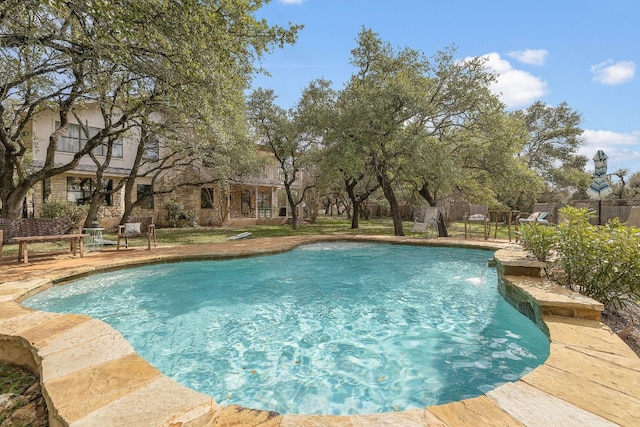 view of swimming pool with pool water feature