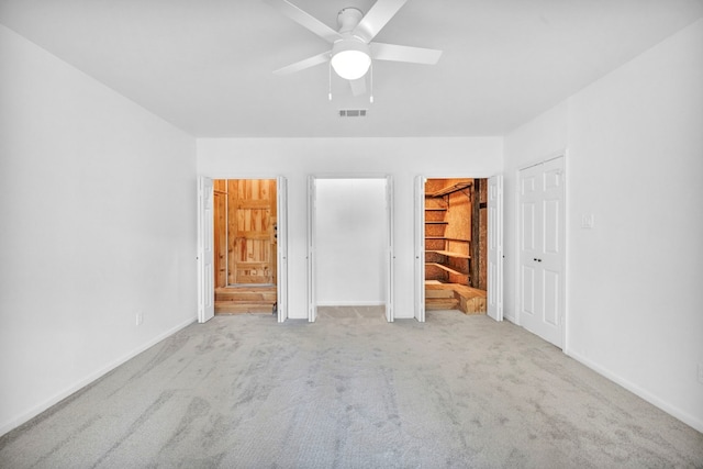 unfurnished bedroom with light carpet and ceiling fan