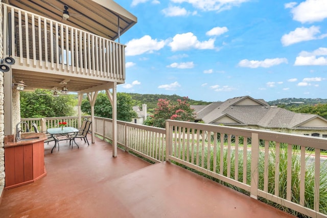 view of patio / terrace with ceiling fan and sink