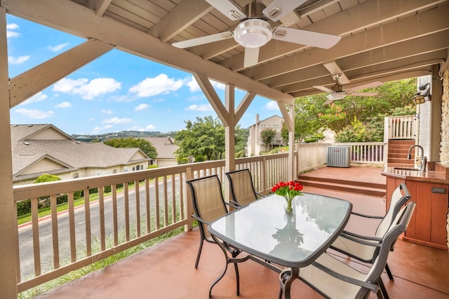 view of patio featuring a wooden deck, sink, and ceiling fan