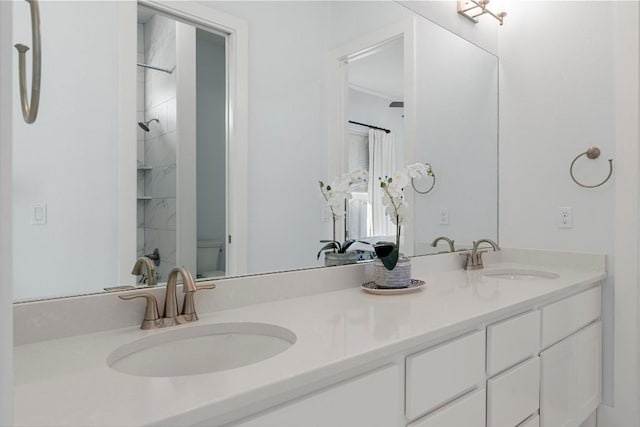 bathroom featuring vanity, a shower, and toilet