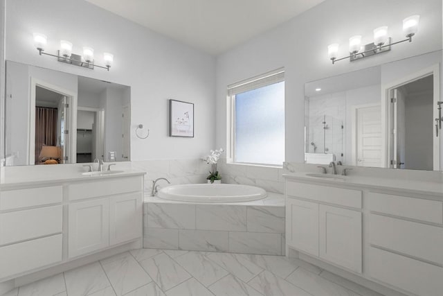 bathroom featuring vanity and shower with separate bathtub