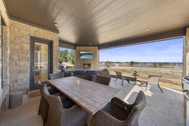 view of patio / terrace with a rural view and an outdoor stone fireplace