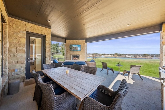 view of patio / terrace with a rural view and an outdoor stone fireplace