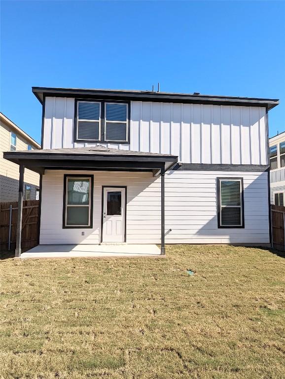 back of house with a yard and a patio area