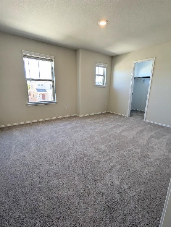 unfurnished bedroom with carpet and a textured ceiling