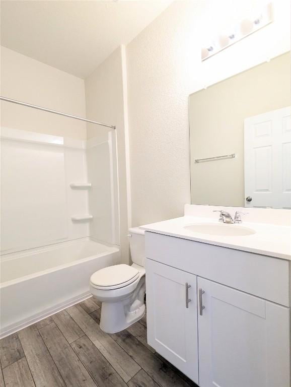 full bathroom featuring shower / bathtub combination, vanity, toilet, and hardwood / wood-style floors