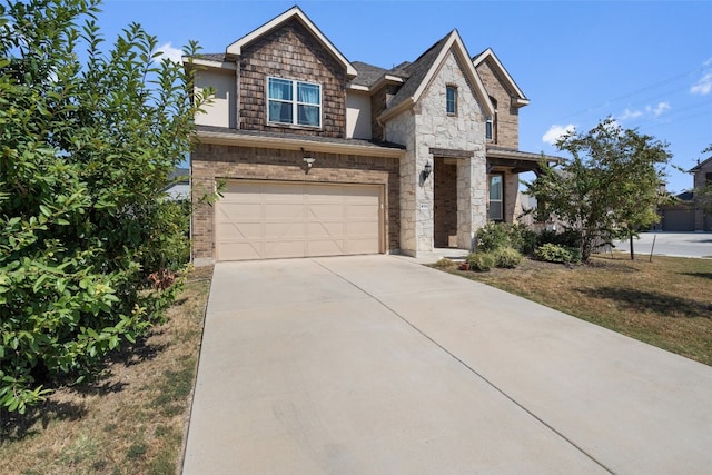 view of front of house featuring a garage and a front lawn