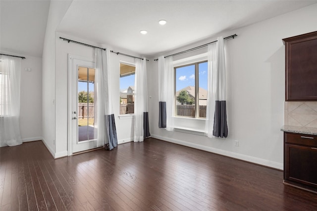 interior space featuring a healthy amount of sunlight and dark hardwood / wood-style flooring