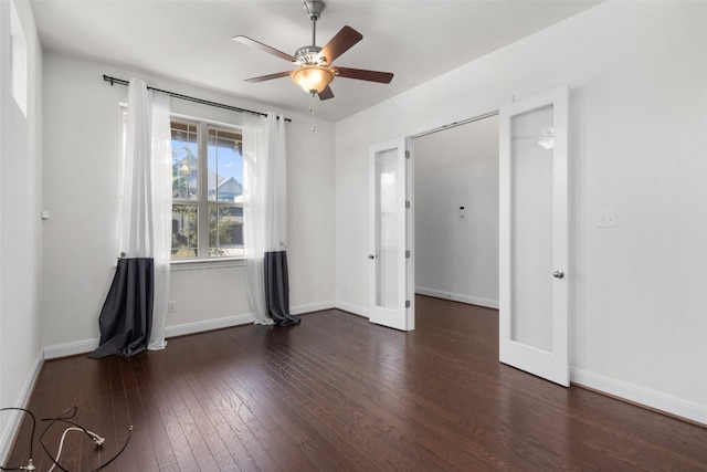 spare room featuring ceiling fan and dark hardwood / wood-style floors