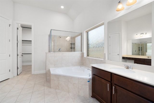 bathroom with vanity, vaulted ceiling, tile patterned floors, and plus walk in shower