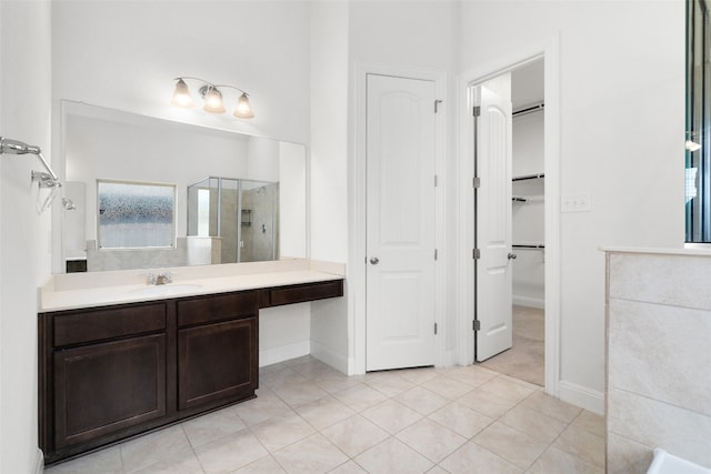 bathroom featuring vanity, tile patterned flooring, and a shower with door