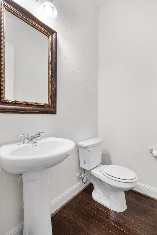 bathroom featuring sink, toilet, and hardwood / wood-style floors