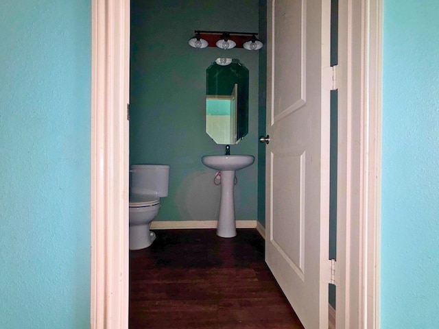 2709 Calypso Pl, Texas City, TX 77568 - bathroom featuring toilet, wood finished floors, and baseboards