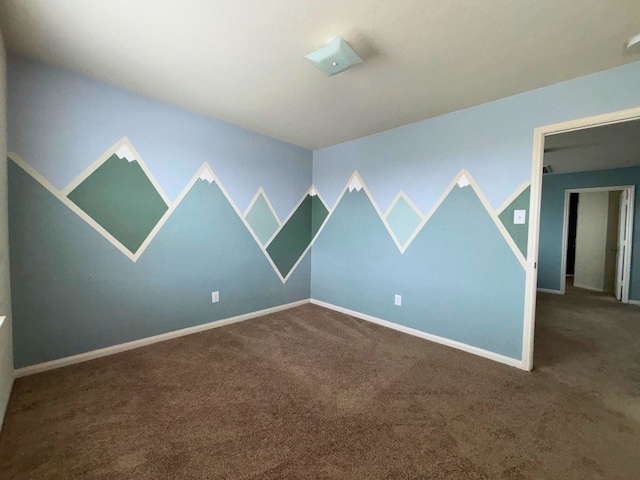 unfurnished room with dark colored carpet