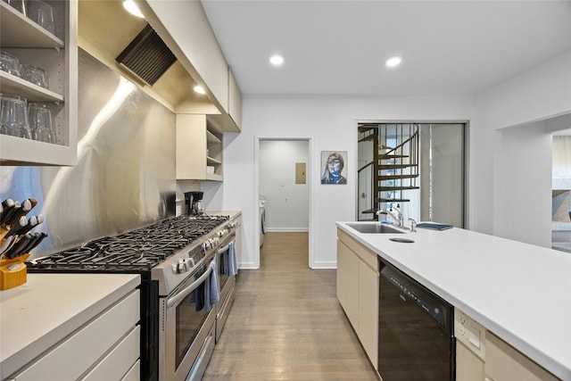 kitchen featuring sink, light wood-type flooring, double oven range, black dishwasher, and cream cabinets