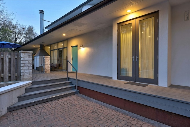 2909 Stratford Dr, Austin, TX 78746 - doorway to property featuring french doors, stucco siding, and a deck