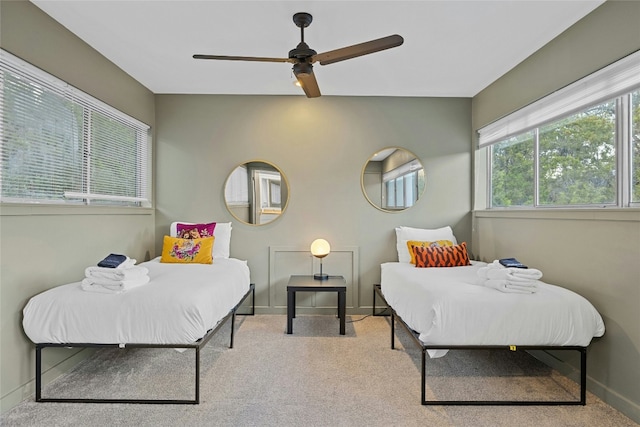 bedroom featuring ceiling fan and light carpet