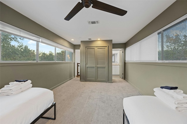 carpeted bedroom featuring ceiling fan