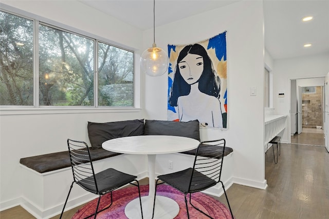 dining space with breakfast area and dark hardwood / wood-style floors