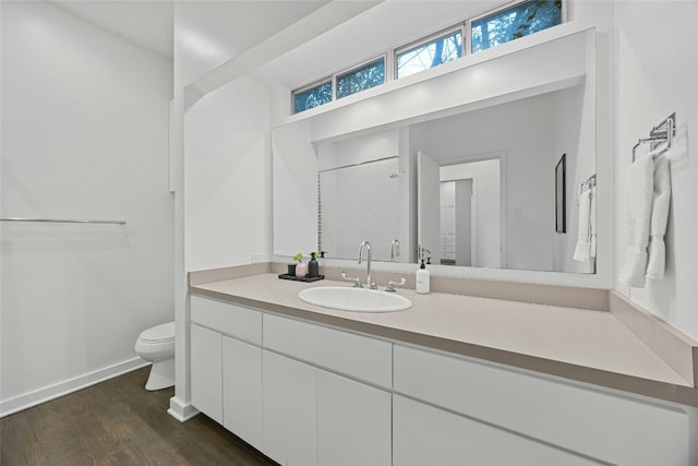 bathroom with vanity, wood-type flooring, toilet, and walk in shower