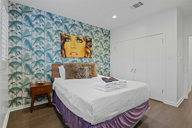 2909 Stratford Dr, Austin, TX 78746 - bedroom with wallpapered walls, wood finished floors, an accent wall, recessed lighting, and a closet