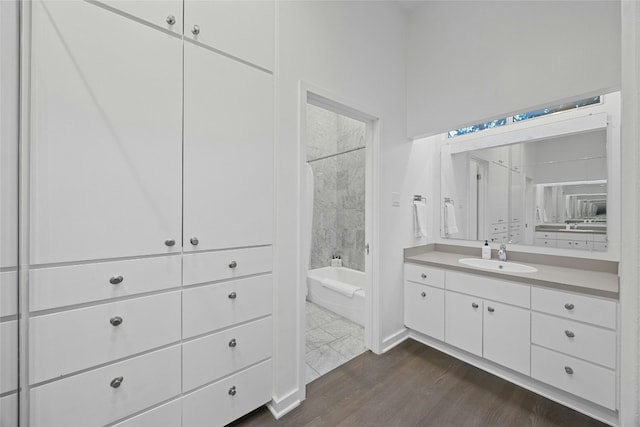 bathroom featuring vanity, wood-type flooring, and shower / bathing tub combination