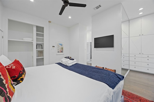 bedroom with light hardwood / wood-style flooring and ceiling fan