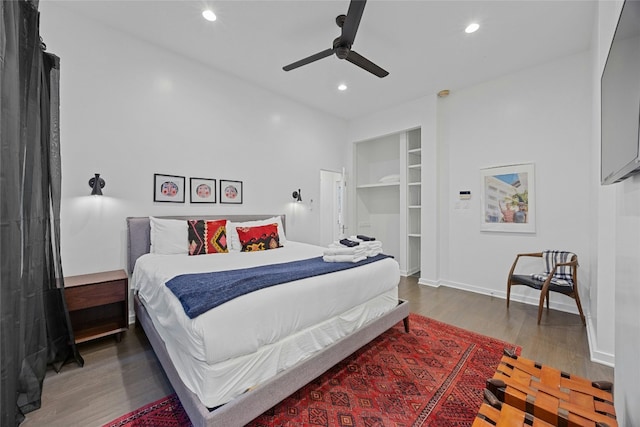 bedroom with ceiling fan and dark hardwood / wood-style flooring