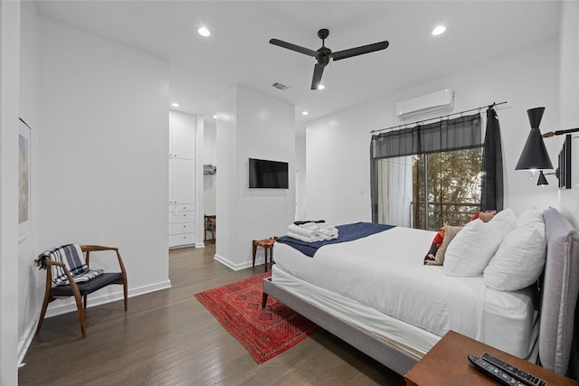 bedroom with ceiling fan, dark hardwood / wood-style floors, and an AC wall unit