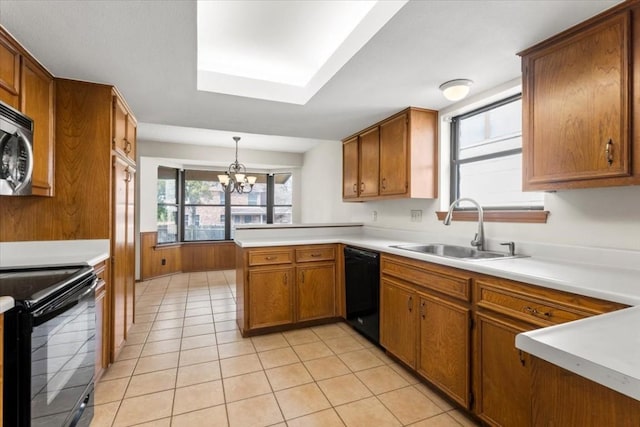 kitchen with sink, hanging light fixtures, light tile patterned floors, kitchen peninsula, and black appliances