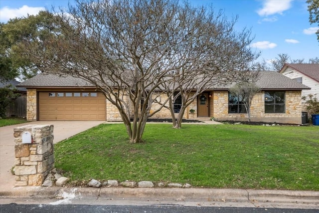 ranch-style house featuring a garage and a front lawn