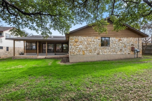 back of property featuring a yard and a patio area