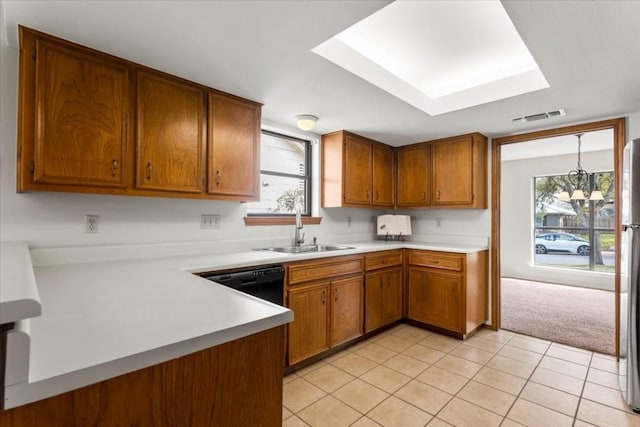 kitchen featuring light tile patterned floors, sink, black dishwasher, decorative light fixtures, and a chandelier