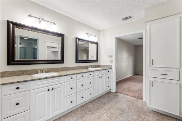 bathroom featuring vanity and a textured ceiling