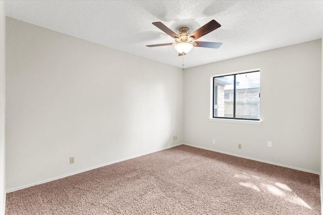 carpeted empty room featuring a textured ceiling and ceiling fan