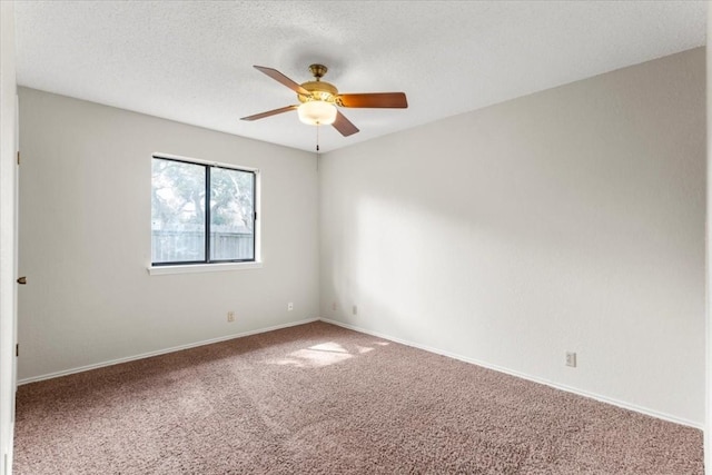 carpeted spare room with a textured ceiling and ceiling fan