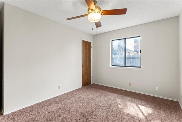 spare room with ceiling fan, carpet, and a textured ceiling