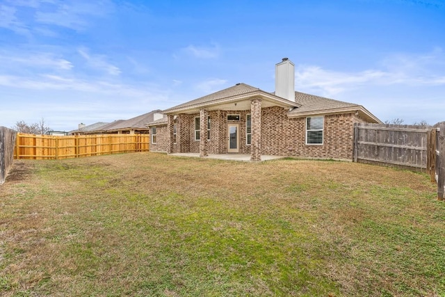 back of house featuring a yard and a patio