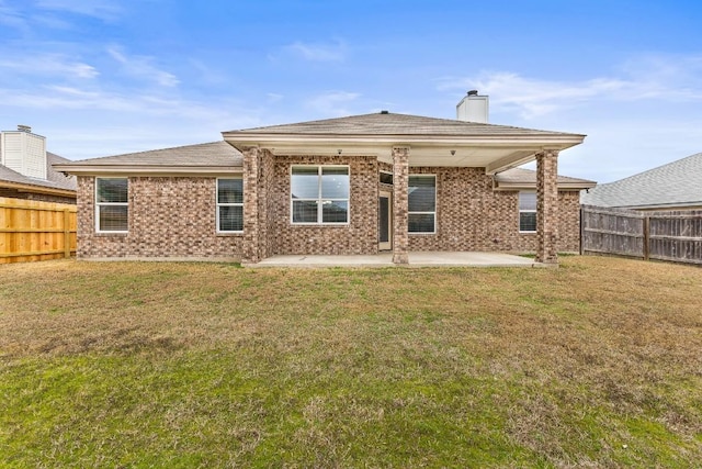 back of property featuring a yard and a patio