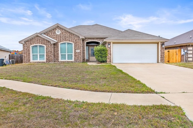 ranch-style house with a garage and a front yard