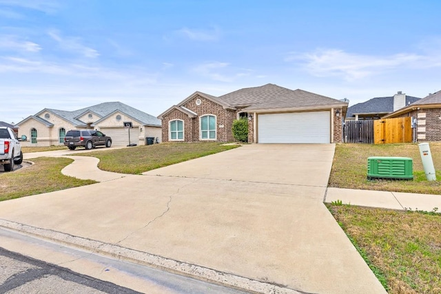 single story home with a garage and a front lawn