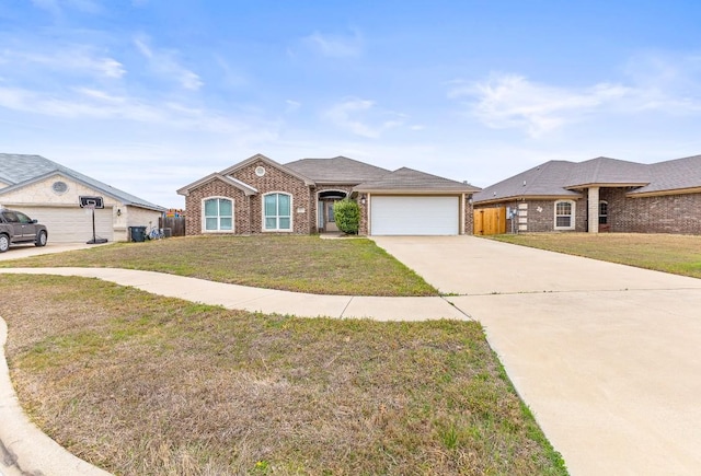 single story home with a garage and a front lawn