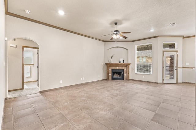 unfurnished living room featuring crown molding, ceiling fan, a textured ceiling, and light tile patterned floors