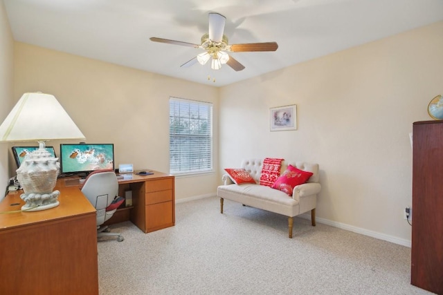 carpeted home office featuring ceiling fan