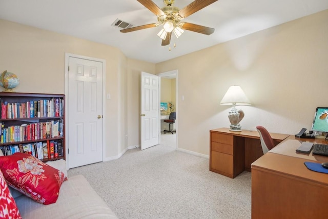 carpeted office featuring ceiling fan